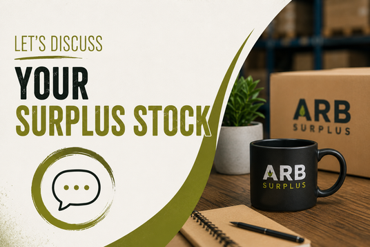 Promotional graphic for ARB Surplus stock, featuring a black mug and cardboard box branded ARB Surplus on a wooden desk next to a small potted plant, with a large off-white graphic overlay on the left containing the text 'LET'S DISCUSS YOUR SURPLUS STOCK' and a speech bubble icon.