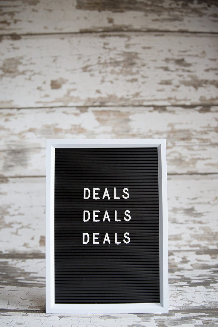 Deals Deals Deal written on a board