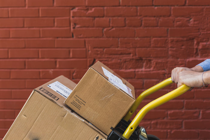 Shipping boxes on a trolly being pushed
